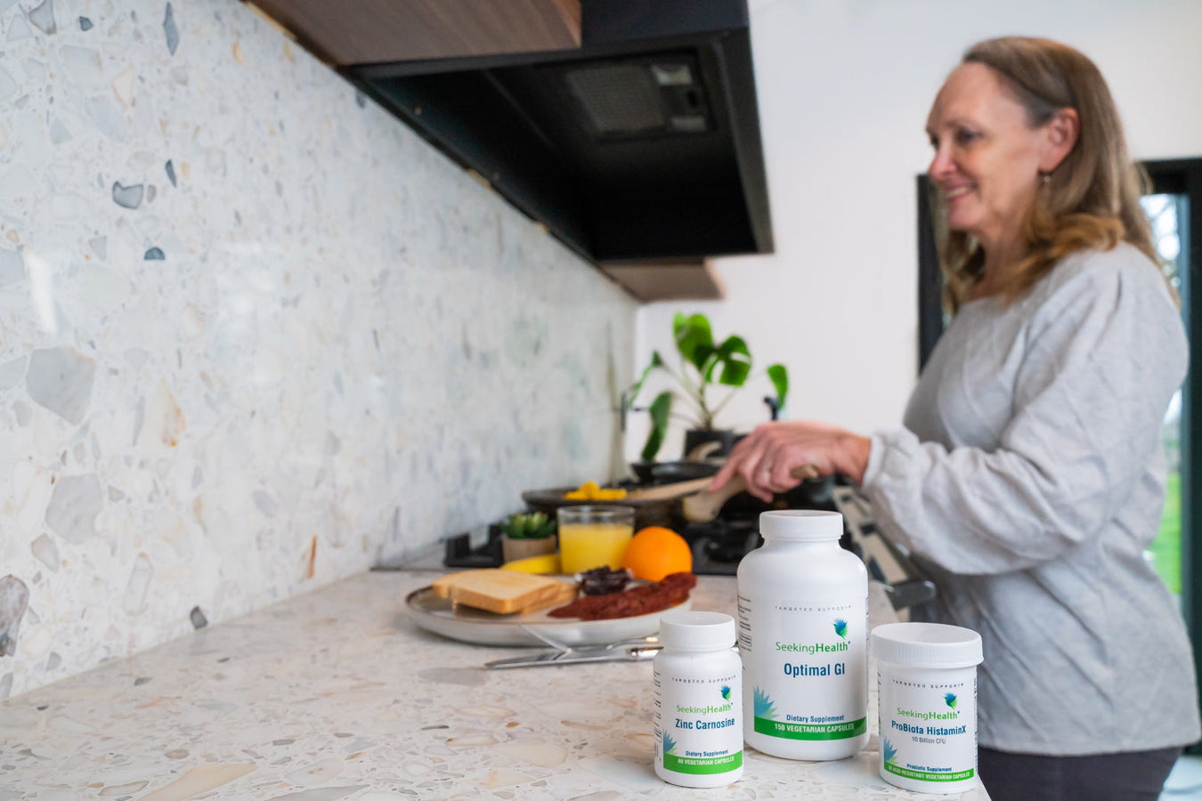 A woman cooking next to Probiotics for histamine intolerance